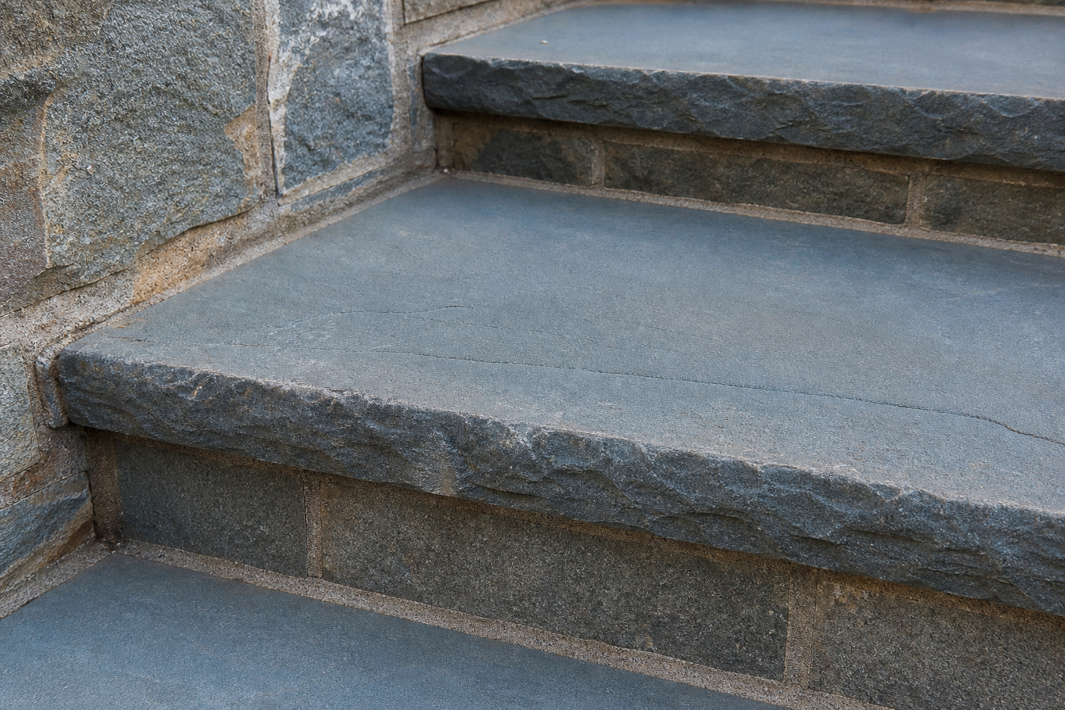 Close-up of bluestone step treads with stone risers and tight joints — representative design concept