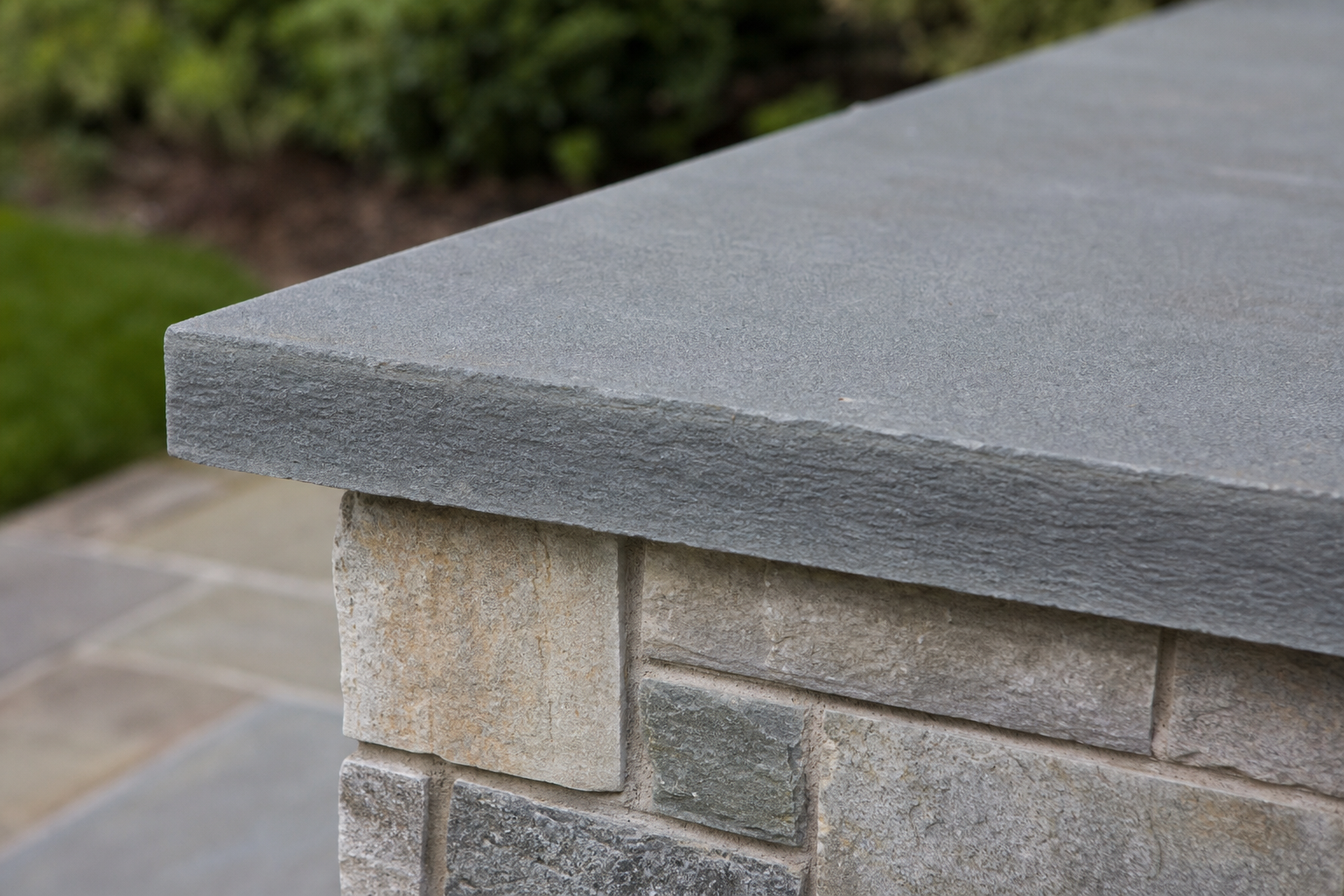 Bluestone cap on multi-tone stone veneer pillar — representative design concept